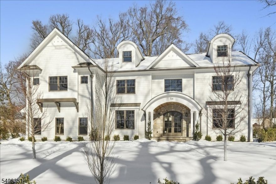 An exceptional Madison offering set on a rare, level .74-acre property in Madison's coveted Hill Section,with over 9500 sq ft of thoughtfully designed living space. The 1st floor is defined by elevated 10-foot ceilings, oversized windows, & abundant natural light throughout. A formal living room showcases custom built-in shelving, while the dining room is enhanced by a sophisticated wine closet ideal for refined entertaining. The kitchen is both timeless & highly functional, appointed w/quartzite countertops, striking pendant lighting, custom cabinetry w/ generous storage, high-end appliances, & a hidden pantry that keeps everyday living beautifully streamlined. Open to the kitchen, the family room is centered around a stone mantel, creating a warm yet sophisticated gathering space. Custom millwork is prominently displayed throughout, including elegant barrel arches and coffered ceilings, complemented by white oak flooring and designer lighting. 7 generously sized BRs, each w/an ensuite bath, include a 1st floor guest suite. A walk-up third floor provides flexible living space, while the finished lower level offers a recreation room, wellness room, second laundry, & an additional bedroom w/a full bath. Designed in collaboration w/ CMM Interiors, the home is rich in craftsmanship and detail throughout. Outdoor living is equally impressive, w/ bluestone patios, a built-in grill area, and a stone fireplace creating a seamless extension of the home's elegant interior spaces.