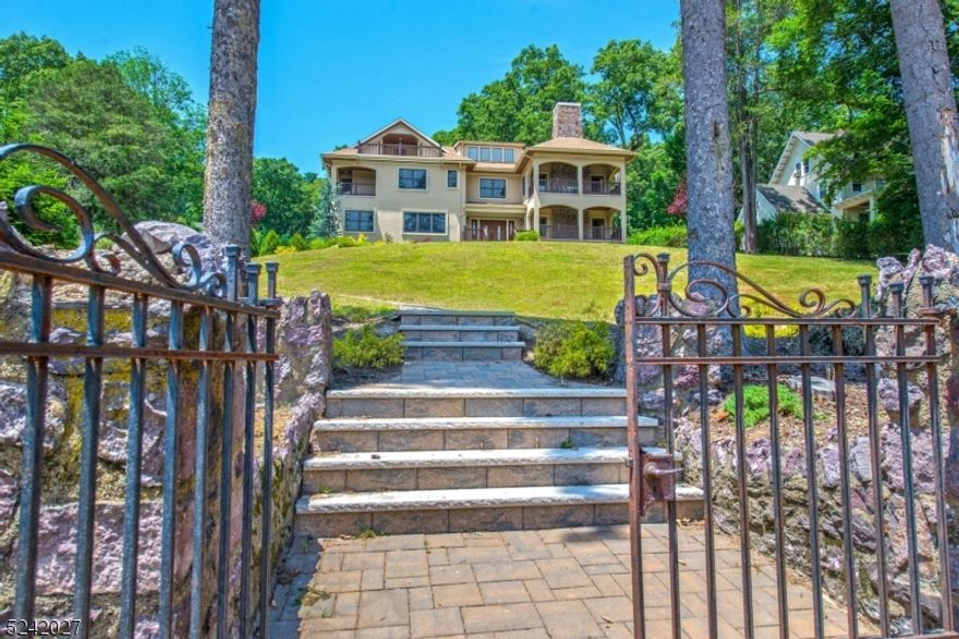 Spectacular Newer Built Luxury Estate, 6 BR 6.1 Bath Colonial w/ Excellent Open Floor Plan! Rare Find in Center of Desirable Lake Community w/ Top Rated Schools! Beautiful Seasonal Lake Views! Gleaming Hardwood Floors throughout 3 Levels! High Ceilings! Stunning Custom Designed Kitchen featuring Canterbury Cabinets, Marble & Granite Counters, Top of Line Appliances, Huge Center Island w/ Breakfast Bar, Butler Pantry & Breakfast Rm w/ French Doors to Deck! Great flow for entertaining as the Kitchen opens into the Family Rm. Beautiful coffered ceilings in Dining Rm & Family Rm. All Bedrooms are en suite! Signature covered porches include the primary suite w/indoor & outdoor gas fireplaces. Additional BR Suite on first level. Finished basement at ground level. Walk to nearby Island Beach, Mountain Lakes Club & NYC Bus! The Boulevard is a prominent street that captures the old world charm of this desirable lake community. Showings will begin on Sept. 8th due to interior being freshly painted and some landscaping spruced up.