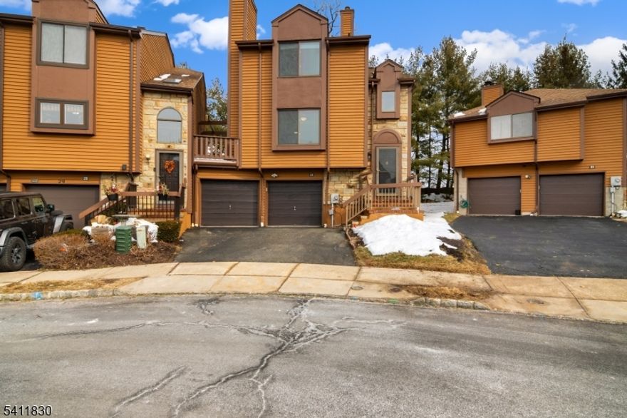 Lovely Brandon 2 model sitting right in the cul-de-sac- this unit has a family room off the kitchen w/ wood-burning fireplace, large kitchen w/ corian counters, built-in pantry & stainless appliances There is also a high-end faucet and tile backsplash. Custom kitchen cabinets & sliding doors from the family room to the large, private deck. Most of the closets have custom California Closets - The living room, dining room and second floor all have hardwood flooring - The master bath has been updated with glass shower and vanity with corian top - There is a balcony also off the master bedroom which is an upgrade - The lower level has a large, finished rec room with separate heating.