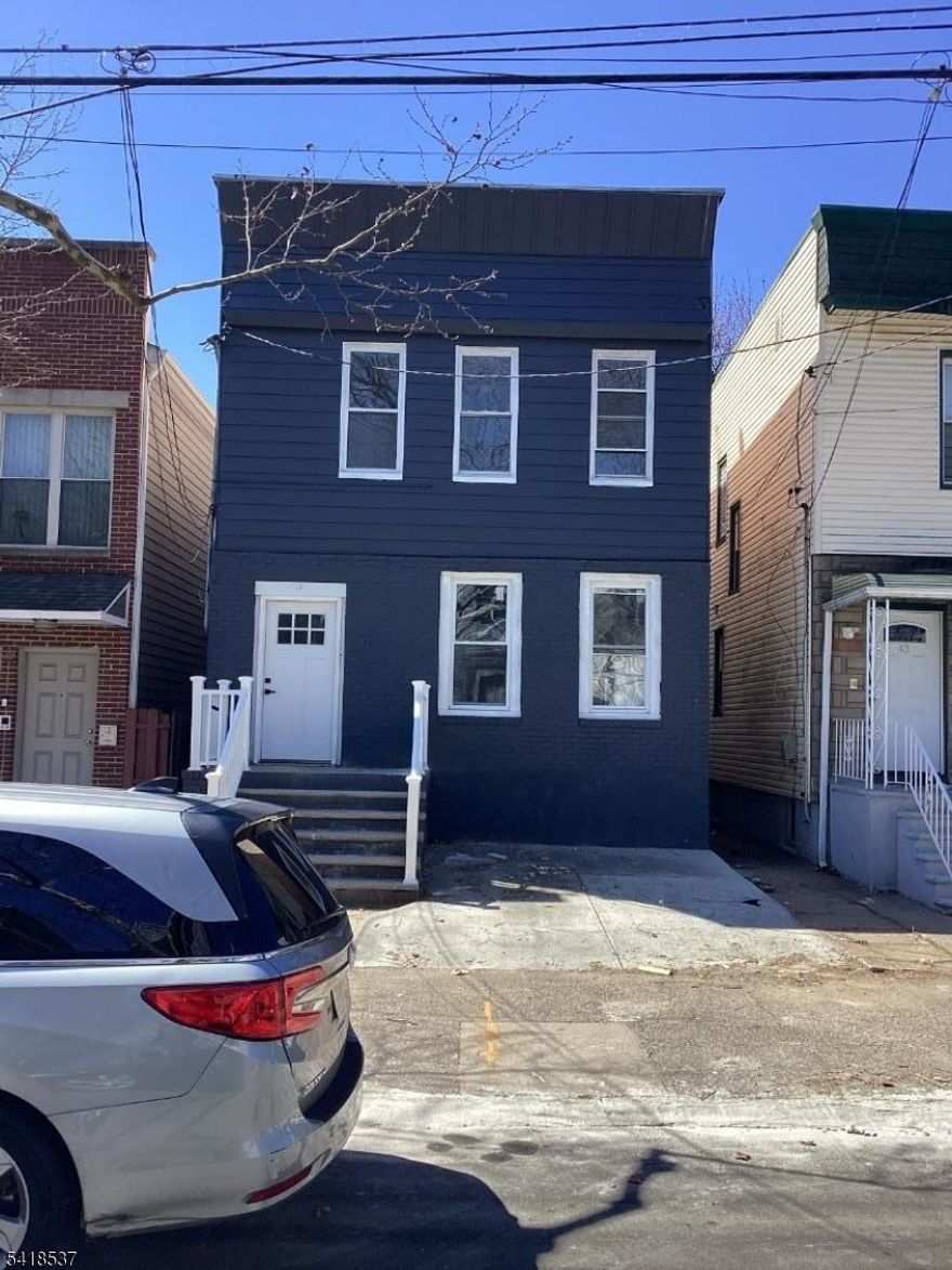 This renovated two-family home features modern, cozy styling with two 3-bedroom units, making it ideal for comfortable living or investment. The property boasts upgraded features including new appliances in both kitchens, stylish baths, new flooring, and recessed lighting. The first floor typically includes a large living room and formal dining area