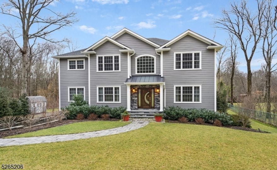 Welcome to 463 River Rd, Chatham, NJ - a newly constructed (2020) 4-bed, 4.1-bath home harmonizing modern luxury with thoughtful design. Efficiency is ensured with a 2-zone forced hot air/central air system, tankless water heater, and Anderson windows. Elegant touches include two stately wrought-iron staircases, solid paneled wood doors, hardwood flooring, and crown molding throughout.Entertain in style in the two-story great room with a coffered ceiling and gas fireplace against a stunning stone wall. The chef's kitchen boasts quartz counters, stainless-steel appliances, and a large walk-in pantry. A first-floor bedroom suite and a formal dining room with decorative molding and a butler's pantry add to the appeal.Practical amenities include central vac, surround sound, and two laundry rooms. The outdoor space features a patio with a koi pond and a built-in firepit. An extra gravel driveway lines the 1.5 acre lot, offering plenty of guest parking. The professionally landscaped yard with underground sprinkler system and outdoor lighting enhances curb appeal. This property offers more than luxury; it's strategically located for convenience near top-rated schools and proximity to NYC direct trains. The oversize 3-car garage with workshop and finished walkout basement complete this Chatham gem. Embark on luxury living at 463 River Rd, where elegance, functionality, and convenience converge seamlessly.