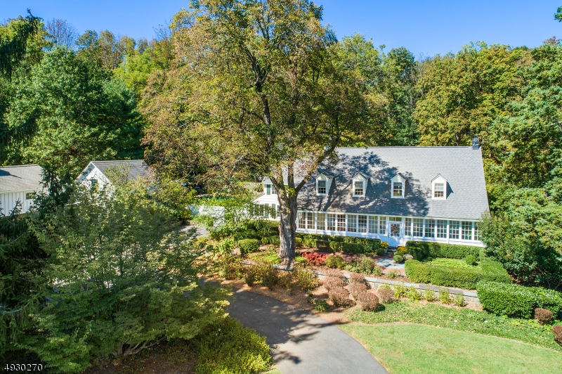 Completely renovated structurally & aesthetically by current owners; wide plank floors, French doors, gas fireplaces, patios and pool, every room offers beautiful views in a private country setting. Modern conveniences include an eat-in kitchen with high-end appliances, master suite, 2nd fl. Laundry, updated plumbing & systems. Spectacular glass-enclosed front porch, chestnut & oak flooring, custom woodwork throughout. Finished barn w/2 horse stalls, 2 car parking, full bath and a finished loft perfectly suited for a professional office.  The expansive property with its split-rail fence, bluestone patios, stone walls and stately trees make a striking setting. Minutes to downtown Morristown, NJ Transit, and 25 miles to Newark International Airport. An exceptional sanctuary perfect for living your best life.