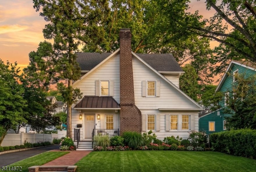 STUNNING 5-BED/3.1 BATH RENOVATED COLONIAL IN ONE OF MAPLEWOOD'S MOST DESIRABLE NEIGHBORHOODS! Lovingly updated & maintained charmer blocks from HS, YMCA, parks, enchanting Maplewood village w/ great restaurants, shopping & entertainment, & quick NJ Transit access into NYC. Soak up the curb appeal of this storybook home in this lovely, friendly neighborhood, noting how the cream-colored wood siding & shutters complement the red brick chimney & wrought-iron railings of the front porch. The magic continues w/ timeless details like cut glass door knobs, hardwood floors & marble tile running throughout the modernized home. First Level boasts open floor plan w/ bright Living Room centered around cozy wood-burning fireplace leading to combined Kitchen & Dining Area where you'll effortlessly prepare & enjoy meals among white cabinetry, quartz countertops, subway tile backsplash, SS appliances inc. gas range & wine fridge & 3-seat center island. Dining Area has room for large table in front of sliding French doors to newer composite deck/patio. Second & Third Levels feature 5 Bedrooms & 2 Full Baths inc. incredible Primary Suite on the 3rd. Open hardwood staircase leads up to your new sanctuary with tall windows, huge walk-in closet & ensuite Bathroom w/ 2-sink vanity, soaking tub & immense walk-in shower! Lower Level is just as spacious & updated w/ Rec Room, Full Bath & Laundry. Move into a flawlessly curated, turnkey home designed for carefree living. Get ready to fall in love!