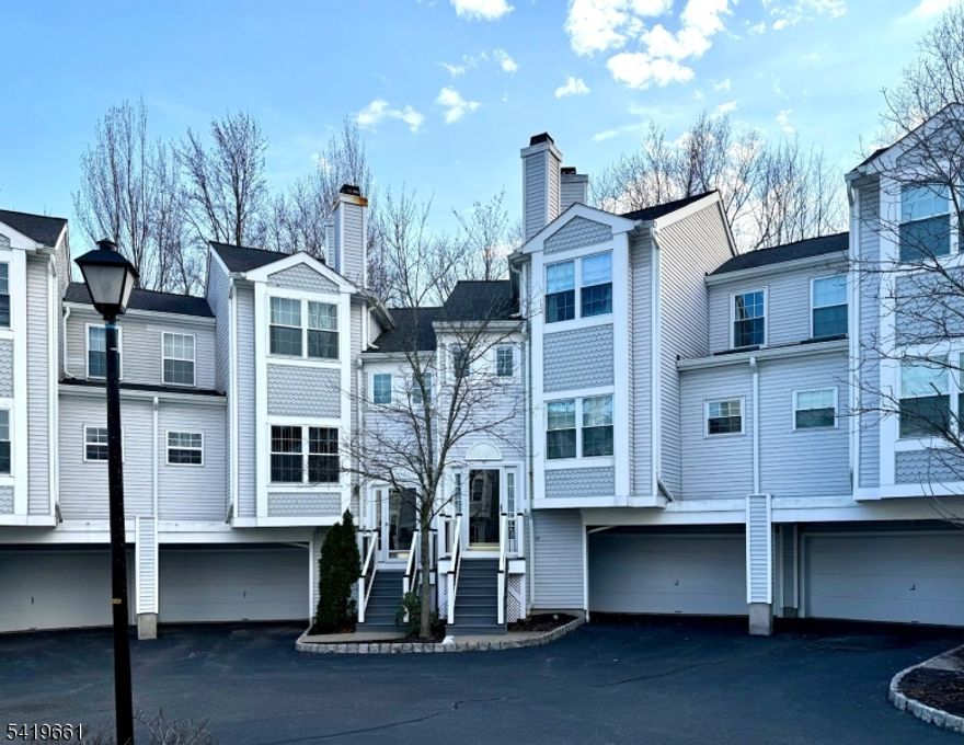 With an artful blend of convenience and comfort, located in the well-regarded Oak Ridge in Whippany, this stunning 3-bedroom, 2.1-bath townhouse with hardwood floors throughout is ready to move into and enjoy! Immaculately maintained, the main floor boasts a natural light-drenched living/family room with a double-sided gas fireplace and crown molding. It flows seamlessly into a den and gourmet kitchen - complete with a peninsula, quartz countertop, white cabinetry, pantry, and a bright skylight - with the dining area opening to a private balcony. The second floor features a spacious en suite primary bedroom with a renovated glass shower, walk-in closet, and two additional bedrooms. The finished ground level features a rec room with a walk-out to the backyard, a laundry/utility room with new HVAC and water heater, and direct access to a 2 car garage. Enjoy the community amenities such as outdoor swimming pool, tennis courts, and clubhouse. Take advantage of low property tax, making this home a smart long-term investment. This home also offers easy access to shopping, schools, entertainment, and major highways.
