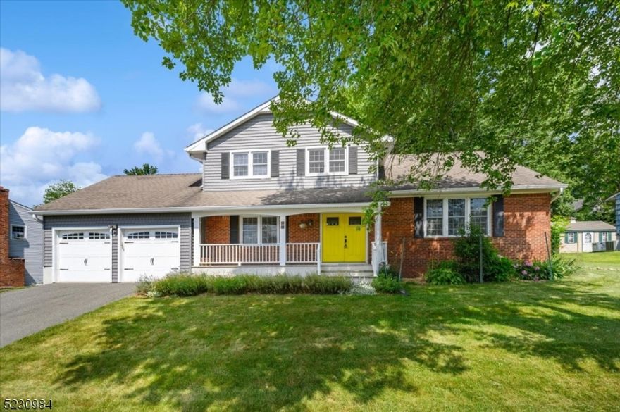 Incredibly Spacious Home, Idyllic Location!  This beautifully updated Colonial style split level home sits on meticulously landscaped property in a quiet area of Succasunna section of Roxbury Twp. near shopping, dining, schools, parks, Horseshoe Lake, and more. Boasting 5 bd, 2.5 baths and an attached 2-car garage, there's room for everyone with plenty of space for relaxing and entertaining. The inviting front porch ushers you inside to a gracious foyer that leads down to a sunny living room with open flow into the dining room and an eat-in kitchen with rich cabinetry, granite counters, SS appliances and a big breakfast nook with tranquil backyard vistas. The welcoming family room features a brick fireplace and bay window, plus garage access and a discreet half bath tucked into the corner. A bedroom off the foyer is ideal as an office or for guests. Up a few steps you'll find a primary bedroom with dual walk-in closets and en-suite bath with shower, with two more bedrooms and a full hall bath completing this level. The top floor has a big bedroom with 3 closets and additional storage space. A sprawling paver patio is perfect for summertime cookouts, with a sprawling backyard beyond offering lots of shade and space for gardening.  This home features gleaming hardwood floors and crown molding throughout, and is also equipped with a whole-house generator. Laundry is currently in the basement, but additional hookups are on the main level. Move-in ready--just unpack and enjoy!