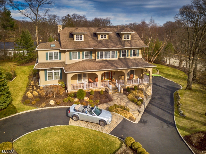 Quality construction and fine details make this 4-level, newer home stand out. Traditional, yet trending with an open flow, this home offers a timeless, convenient design. A truly unique find in town. Graciously adorned with exquisite woodwork,10 foot ceilings, a wealth of French doors and spacious rooms, the home features large doorways and open spaces that perfectly accommodate gatherings and everyday living.  Modern conveniences and spaces including: a gourmet kitchen open to the large family room, spacious bedrooms, 3 car garage and finished basement provide the must haves for today's buyers. Adjacent to a town park at the tip of a cul-de-sac, behind the library, steps from restaurants and walk-able to schools and lake, this delightful home presents the rare new home option in sought after Mountain Lakes.