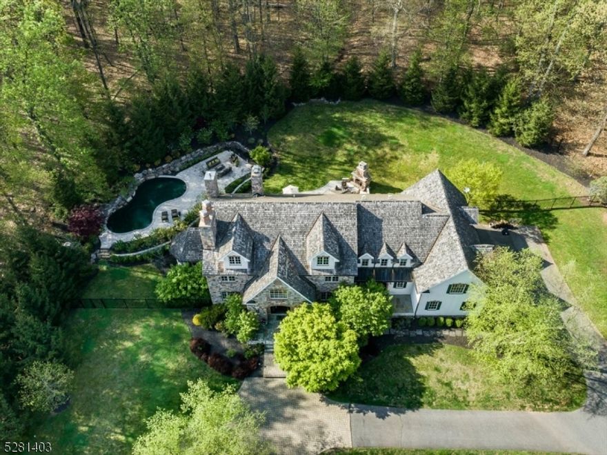 Architecturally stunning European-inspired country estate privately situated on 4.8+ tree-lined acres in the sought after Roxiticus Valley. With its private setting and elegant finishes, this home is truly the epitome of style and grace. Exterior features a striking blend of stucco and fieldstone with cedar-shake roof and copper accents. Timeless interior with extensive moldings, wainscoting, intricate wood floors, multiple fireplaces, coffered ceilings & french doors. Exceptional layout featuring gourmet kitchen w/ breakfast room, dining room, family room, formal living room, first floor office, conservatory, guest bedroom with full bath nearby,  mudroom with laundry & pet shower and 4 car garage. Second level features a main bedroom suite w/ fireplace, two walk-in closets & bath, lounge, and three additional bedrooms - all with en suite baths and secondary laundry. Four finished levels including third floor bonus room and finished lower level with theater, game room & recreation area. Expansive terraces, heated gunite pool w/ waterfall feature, outdoor fireplace and extensive landscaping. Rear yard is fully fenced and backs to 285 acres of parkland. Located in Winston Farm at the end of a cul-de-sac with a meandering approach and circular drive. Far Hills mailing address. Close to multiple quaint towns. Hunt Country lifestyle amenities include nationally ranked golf courses, equestrian facilities, shopping, fine dining, acclaimed public & private schools, NYC train lines.