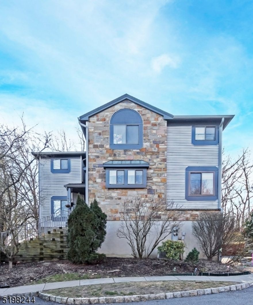 Beautiful end unit townhouse in The Hills of Independence. Hardwood floors in the dining room which leads into the light and bright living room, with sliders to a private deck with wooded views. The updated gourmet kitchen is a chef delight! Bathrooms are updated as well, and laundry is on the second floor. The home also has a 2-car garage and is located close to everything, including downtown with fine dining, shopping, mass transit and Route 80 for easy commute into NYC. Amenities include a pool, tennis courts, park, and clubhouse. Come see all this great home has to offer.