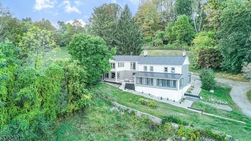 28 ACRES of FARM ASSESSED PROPERTY SET ON A HILLSIDE with MAGNIFICANT VIEWS featuring 3 LEVEL FIELDS of OPEN & WOODED LOTS, VERY LOW TAXES, PERFECT FOR FARMING, AGRICULTURE OR POSSIBLE SUBDIVISION & currently income producing. This charming original farmhouse boasts large windows that fill the home with natural light offering stunning countryside views.  4 / 5 bedrooms, living room, formal dining room, recreation room, family room, & a unique 3-season room with a wood-beam ceiling and brick-faced fireplace, ideal for relaxing or entertaining. One of these spaces could be used as an office/exercise room. The home is available furnished (few exceptions), features newer gleaming floors & warm, inviting colors throughout. Stay cozy in winter with two fireplaces/wood-burning stoves. First floor master bedroom & bath provide privacy, while the gourmet eat-in kitchen with a center island, stainless-steel appliances, side entry to a laundry/mud room, new roof, windows, hot water tank, & Hardie board siding. The property includes two above-ground oil tanks, newer appliance. Additional features include 3 sheds, one of which is new- equipped with electricity, water, AC/heat, & an inviting outdoor fire pit. Just an hour from NYC, close to the Poconos / Pennsylvania border, this property offers a perfect mix of suburban charm & recreational opportunities. It is conveniently located near Routes 80 & 46 for easy commuting & is surrounded by excellent schools including Blair Academy.