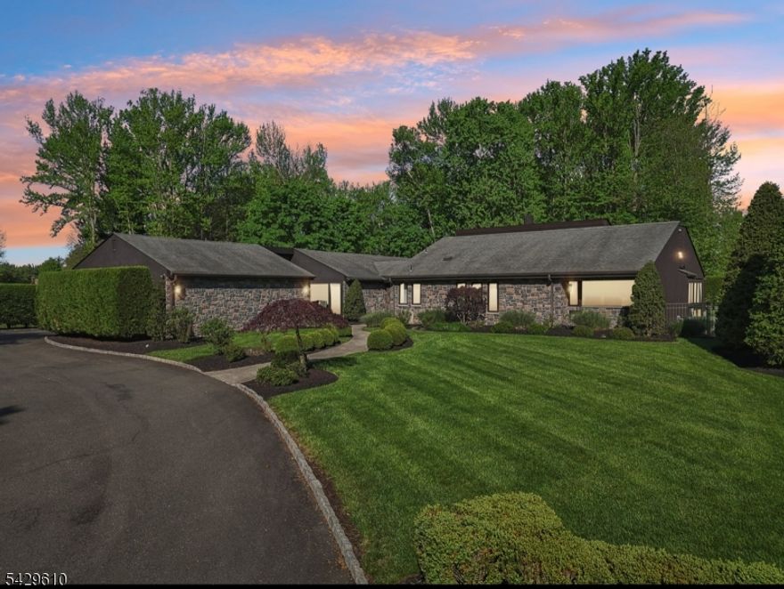 Welcome to this sprawling Custom Ranch offering exceptional privacy and luxury on just over an acre of lush, professionally landscaped property. Nestled at the end of a tranquil cul-de-sac, this one-of-a-kind home features 5/6 bedrooms and 3.5 baths, thoughtfully laid out with two distinct bedroom wings situated 60 feet apart. The open-concept main level boasts soaring ceilings throughout, including 12-foot ceilings in the kitchen and family room, 15 feet in the primary suite, and an impressive 18 feet in the formal living room. Natural light floods the interior through floor-to-ceiling windows, highlighting elegant finishes like designer chandeliers, Phillip Jeffries wallpaper, and a wood-burning fireplace.The heart of the home is the stunning designer kitchen a true showpiece with an 8' x 8' island, Thermador appliances, 4-foot galley sink with built-in coffee and appliance stations, warming drawer, dual dishwashers, wine fridge, bar sink with instant hot water, walk-in pantry, vaulted ceilings, and Rocky Mountain Lenny Kravitz hardware. Decorative trusses and a blend of form and function make this space both striking and practical.The fully finished basement offers additional living space with a separate living area, bedroom, and full bath perfect for guests, a nanny suite, or home office.Step outside to your own private oasis, featuring 2 distinct outdoor seating areas ideal for entertaining or relaxing. A rare find with designer touches throughout. Don't miss this one!!