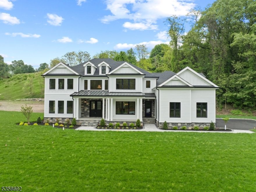 Stunning, custom-built luxury home with approx. 5,600 sq ft of finished living space, plus an additional 2,500 sq ft (approx.) of basement ready for your personal touch.  Features 5 spacious bedrooms, each with en-suite bath and ample closets, plus a powder room. Enter through double doors into a dramatic two-story foyer with oak railings and metal balusters. First floor boasts 10' ceilings, guest/in-law suite, formal dining room with butler's pantry, office or formal living room, side entrance with mudroom closets, and a bright family room with fireplace open to the gourmet kitchen.Kitchen includes a 6-seat island, JennAir appliances, quartz countertops, porcelain backsplash, pot filler, walk-in pantry, and custom cabinetry. High-end finishes throughout: wide plank hardwood floors, solid wood doors, crown molding, Kohler fixtures, Andersen windows, central vacuum, and custom closets. Luxurious primary suite with tray ceiling, spa-like bath with soaking tub, shower, double vanity, and walk-in closet. Bonus second-floor flex room and laundry.Exterior features: covered front porch with metal roof, paver patio, Belgium block-lined driveway, professional landscaping, underground sprinklers, and multi-zone hydronic heating system.