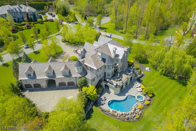 Throughout this architecturally significant stone and stucco home there are constant reminders of Old World elegance and luxury. The well thought out floor provides fabulous entertaining space for everyday living.   Spacious rooms, featuring warm woods and large windows, bring charm and character to every room.  The large gourmet kitchen is strategically designed to accommodate the most versatile host whether serving indoors, outdoors or poolside.  The romantic primary bedroom suite boasts a gorgeous en suite, two walk in closets, gas fireplace, and private patio overlooking the serene backyard.