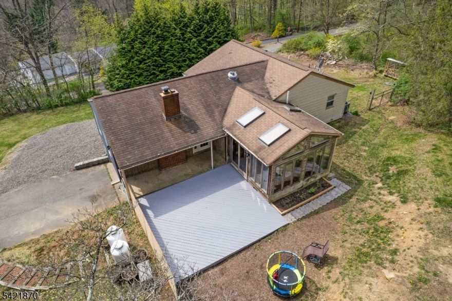 BEAUTIFUL CUSTOM RANCH TOTALLY REMODELED WITHIN THE PAST 10 YEARS.   This home features a gourmet style kitchen with vaulted ceilings, newer appliances, center island, skylights and wall of window flooding the space with plenty of natural light.  The first floor also boasts a large 19 x 19 living room with fireplace, and dining room.  There is a primary bedroom and luxurious full bath with rain shower. There are 2 more bedrooms on this level as well as a second full bath.  There are hardwood on the entre first floor.  The lower level consists of a large rec. room with wood stove, Laundry room, utility room and access to the 2 car garage. The more recent updates include a new septic in 2012, new heating system, central air, and hot water heater in 2023.  The home is situated at the end of a dead end street. Privacy and yet just minutes to the center of town and an easy commute to major highways.