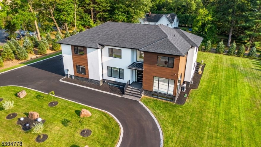 NEW CONSTRUCTION Welcome to perfection in Montville, NJ! This new construction blends modern luxury with comfort in a prime location near top-rated schools with 5,600+ sqft of living area spanning 3 floors. This home features five spacious bedrooms, three and a half bathrooms, and a versatile flex room. On the second floor, you'll find four bedrooms, including a luxurious master suite with a walk-in closet. The finished basement is a standout, offering a dedicated office space and a vast area ideal for a bar and game room. Enjoy the warmth of heated floors throughout, including in the basement and on the front entrance steps. The gourmet kitchen is a chef's dream, equipped with top-of-the-line appliances and sleek countertops. European windows with a 2-step opening allow natural light to flood the home, while the stereo and security systems, central vacuum, and high-efficiency heating/cooling ensure convenience and comfort. The landscaped grounds feature a 1,350 sqft porcelain tile patio, perfect for summer barbecues, and an in-ground sprinkler system. Trees beautifully enclose the property, and the landscape is fully finished and ready for new owners. Additional features include a 950sqft 3-car garage with a wrap-around driveway and EV charging access. Plus, the huge sliding door in the living room offers seamless access to the outdoors, and you're less than a 5-minute drive to the train station. 10 Year HW included. Schedule your tour today!