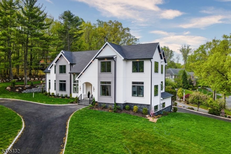 Welcome to an extraordinary Short Hills contemporary masterpiece nestled in the prestigious Deerfield Section. This newly built 7-bedroom, 6.2-bath home offers approximately 7,800 square feet of impeccably designed living space across three levels, all set on a half-acre of beautifully landscaped, private grounds.Arrive with elegance via the circular driveway and step into a stunning two-story foyer that immediately captivates. The spacious family room boasts soaring 20-foot ceilings, a striking DOUBLE SIDED FIREPLACE, and seamless access to a private patio-perfect for relaxing or entertaining. The chef's dream kitchen is outfitted with premium Wolf and Sub-Zero appliances, TWO DRAMATIC WATERFALL ISLANDS, designer cabinetry, and a large walk-in pantry. A convenient first-floor guest suite ensures comfort and privacy for visitors.Retreat to the primary suite, a true sanctuary featuring a spa-inspired bathroom and dual custom walk-in closets. Additional highlights include a floating staircase, custom built-ins throughout, a 3-car garage, and a fully equipped wet bar in the basement. This smart home is integrated with Ring security, Nest thermostats blending cutting-edge technology with sophisticated living. Ideally located near top-rated schools, major highways, and premier shopping, this residence offers an unparalleled lifestyle. Experience the perfect harmony of refined design, luxurious amenities, and an unbeatable location.