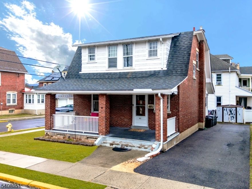 Welcome to this charming all-brick colonial, perfectly situated on a desirable corner lot with a fully fenced-in backyard. Step inside to find hardwood floors and original hardwood trim throughout, adding warmth and timeless character. The main level offers a bright, comfortable living room, formal dining room and an eat-in kitchen. Upstairs, you'll find two generously sized bedrooms, each featuring walk-in closets, along with a well-appointed full bathroom. The full basement with a Bilco door provides excellent storage options and potential for a workshop, hobby space, or future finishing. Enjoy the cozy covered front porch for relaxing mornings, and a spacious back porch overlooking the yard perfect for evenings by the fire pit. A convenient storage shed and off-street parking for up to three cars enhance everyday ease. Recent mechanical updates include a 2024 water heater, plus furnace and central A/C from 2014. All updated electrical. Gutters and both porch railings replaced in 2018. The home is serviced by public water, public sewer, and natural gas, offering reliability and efficiency. Lawn mower, BBQ grill and patio furniture all included with home!