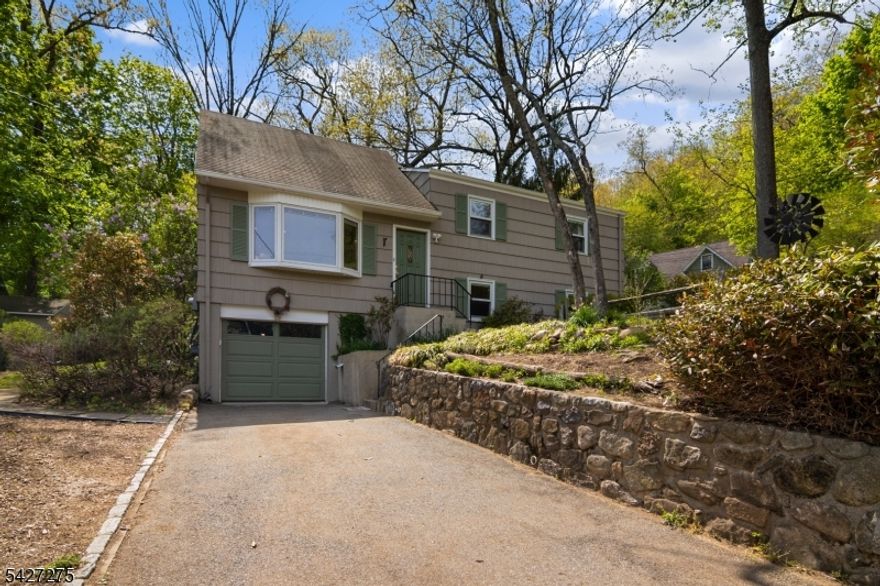 Cedar Lake living with seasonal lake views, set on a quiet corner lot. This well-maintained home offers generous room sizes, beautiful hardwood floors throughout, and bright, sun-filled living spaces. The newly renovated kitchen is the heart of the home, featuring an open floor plan, center island, stainless steel appliances, and a stunning tile backsplash, seamlessly flowing into the dining and living areas perfect for everyday living and entertaining. The first floor includes a formal living room, dining room, and sliders to an oversized back deck. A spacious family room with cedar shiplap, full bath, and walkout mudroom adds flexibility. Upstairs offers three bedrooms and a full bath, while the finished third level provides a private retreat ideal for a primary suite, office, or bonus space. The backyard is a standout level, fenced-in, and anchored by an oversized deck, creating an ideal setting to relax or entertain. Additional features include a one-car garage, basement storage, and ample off-street parking. Only a few steps away to the cedar lake community play ground and Just minutes to downtown Denville with its vibrant mix of shops, restaurants, and community events. Easy access to NYC direct transit and major highways. Natural gas, central air, and public utilities complete the package.