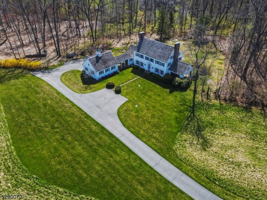Tucked away on Young's Road, this meticulously designed ten-room classic colonial residence graces over ten acres of pastoral land. Designed by the esteemed New Vernon architect, Patrick Burke, this home promises comfortable country living with scenic views from every vantage point. With endless opportunities, this 4 bedroom, 2.2 bath home is waiting for its next owner. Upon entering the inviting foyer, take notice of the gracefully curved walls that open to the spacious dining and living rooms. The eat-in kitchen, which provides direct access to the yard is flooded with abundant natural light. Adjacent to the kitchen, the family room with its vaulted ceilings, architectural beams and wood burning fireplace creates a cozy space for gatherings, seamlessly connecting the indoors with the outdoors. Additionally, the first floor offers a convenient mudroom with access to garage via open breezeway, laundry area, and 2 half baths.  On the second floor, the primary ensuite is a peaceful sanctuary with a separate dressing area, double closets, and wood burning fireplace.  3 additional bedrooms and a hall bath complete this floor.  Above the garage, you'll find a bonus room that offers expansive views of the serene property.  Beyond the home is an additional 2 car detached garage with attached storage room. This exceptional property harmoniously blends timeless design, comfort, and natural beauty, a true gem for those seeking a tranquil retreat.
