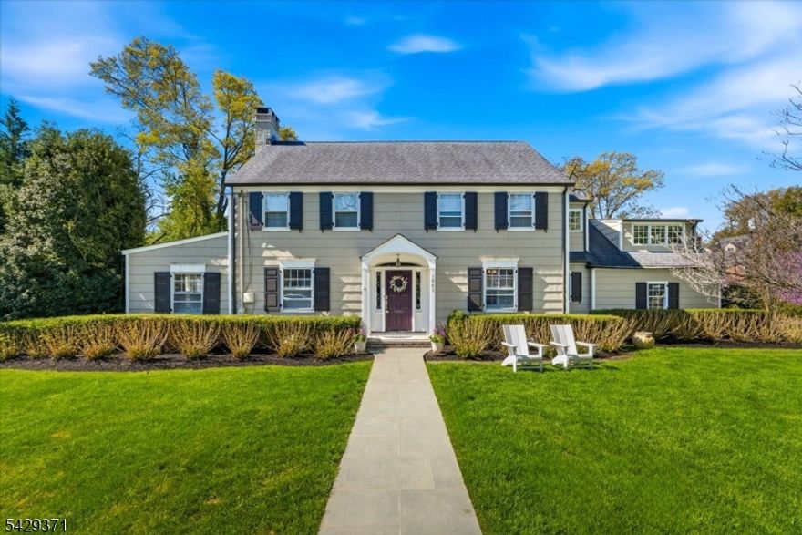 Welcome to 1061 Wychwood Road, a beautifully renovated Colonial on a prime corner property in one of Westfield's most coveted neighborhoods adjacent to Echo Lake Country Club. Thoughtfully redesigned by Michael Roberts in 2016, this 4-bedroom, 3.1-bath home offers a refined balance of timeless architecture and modern livability. A gracious foyer introduces a seamless main level where formal and informal spaces connect w/ease. The living room flows into a warm, inviting den w/double-sided fireplace, while a well-positioned dining room is ideal for both everyday living and entertaining. The designer kitchen w/premium finishes opens to a sunlit breakfast area and overlooks main living spaces, creating a natural hub for daily life. Kitchen has an electric induction stove top and gas double ovens. A screened porch extends the living outdoors, ideal for morning coffee or evening entertaining, while mudroom and direct garage access add convenience. Thoughtfully designed interiors feature custom coffered ceilings, built-ins, and hardwood floors throughout, bringing warmth, depth, and continuity to light-filled, well-proportioned spaces. Upstairs, four spacious bedrooms including a serene primary suite w/WIC and spa-inspired bath w/Swarovski crystals, stall show and claw footed tub. The finished lower level provides versatile space for recreation. Outside, landscaped grounds create a private retreat w/irrigation, lush lawn, and flowering trees. Opportunities on this street don't last.