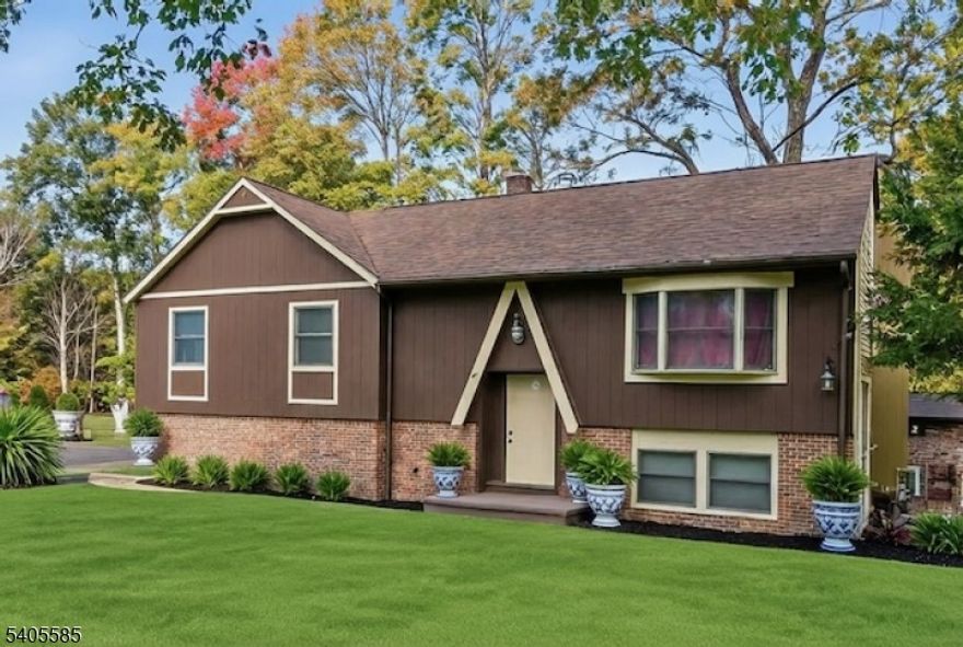 Welcome to East Brookwood Estates! This well-maintained 4-bedroom, 2.5-bath bi-level is ready for its next chapter. Perfectly situated in a quiet neighborhood, this home offers a fantastic, spacious layout and solid bones. With several major mechanical upgrades already completed, it provides the perfect foundation for someone looking to move into a great community and easily add their own personal touches to make it home. The upper level features a large kitchen with vaulted ceilings and skylights that open up the space. Just off the kitchen, the living room includes hardwood floors and a large window for plenty of natural light. This level houses the primary suite with its own full bath, plus two additional bedrooms and a recently renovated main bathroom with a tub/shower. The walk-out lower level includes an inviting family room anchored by a wood-stove fireplace. This level also contains the fourth bedroom, a half bath, the laundry room, and interior access to the garage. The exterior is well-kept with a large deck for entertaining and a rear paver patio overlooking the yard. The oversized 2-car garage includes newer doors and extra workspace. High-Ticket Updates: many newer energy-efficient Anderson windows - Newer mini-splits providing cooling to a large portion of the home - Newer boiler for peace of mind. - spetic repair permit pulled and will be completed prior to closing.