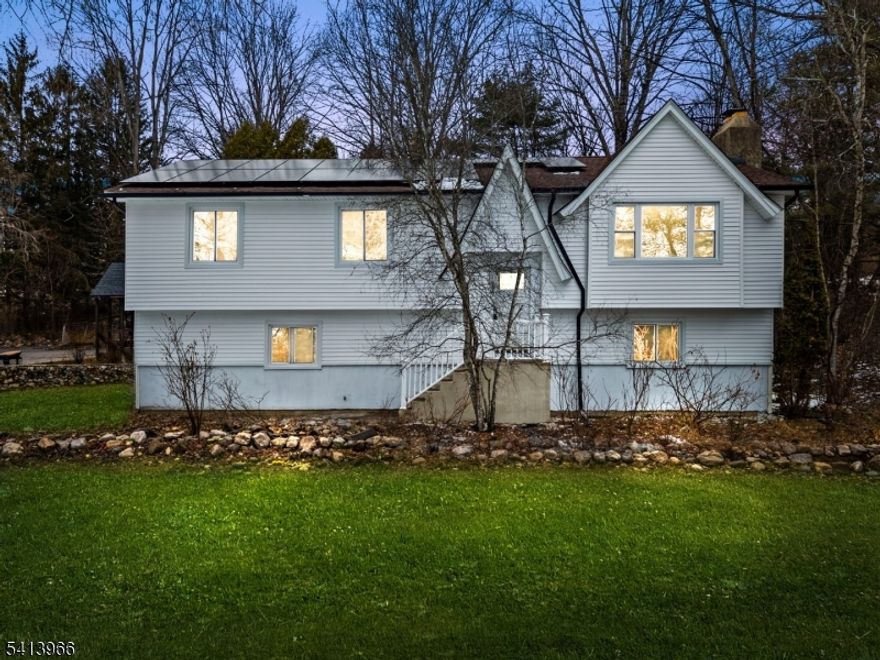 Welcome to this fully renovated bi-level home with a desirable mother/daughter setup, perfectly situated on 3 private acres. Offering 4 bedrooms and 3 full bathrooms. The main level features an open-concept layout with new vinyl flooring, fresh paint, recessed lighting, and all new interior doors with updated hardware. The brand-new kitchen offers quartz countertops, stainless steel appliances, and flows seamlessly into the living and dining area. Step outside to the oversized deck, ideal for entertaining or enjoying the scenic property. The upper level also includes a spacious primary suite with a private renovated bathroom and two closets, including a walk-in, along with an additional full bathroom featuring double vanities. The lower level offers excellent flexibility, complete with a separate living area, one bedroom, and a full bathroom, plus a custom wood-burning fireplace with shiplap. A second stone wood-burning fireplace on the upper level adds warmth and character. New windows, new roof, new soffits, new gutters, new vinyl front facade, and new garage doors. Central air, forced hot air heat, and solar panels designed to significantly reduce or potentially eliminate electric bills depending on usage. A rare opportunity to own a beautifully updated home with acreage, privacy, and versatile living space which offers room to grow.