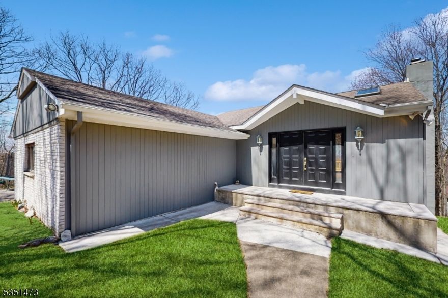 Smoke Rise, one of New Jersey's most sought-after gated communities, is home to this stunning California-style ranch, offering breathtaking sunrise and sunset views through walls of windows and 35 miles of mountain scenery. This sunlit home features soaring ceilings, skylights, and an open floor plan that flows effortlessly to a massive 70-foot tiered wraparound deck, accessible from the great room, living room, and two bedrooms. The main level includes 3 bedrooms and 2.5 baths, a spacious primary suite with full bath, a custom kitchen, hardwood floors, and two fireplaces perfect for cozy mornings or evenings. The walk-out basement provides additional living space and a covered deck, ideal for entertaining or relaxing. Circular Driveway leads to a 2-car garage with main level entry. Recent updates include a 2023 hot water heater. Enjoy all that Smoke Rise has to offer: lake access, dining, social events, and more just minutes from Rt 23, transit, top-rated schools & 35 miles away from NYC. ***Seller requesting Highest & Best offers by Monday April 28th at 12 pm