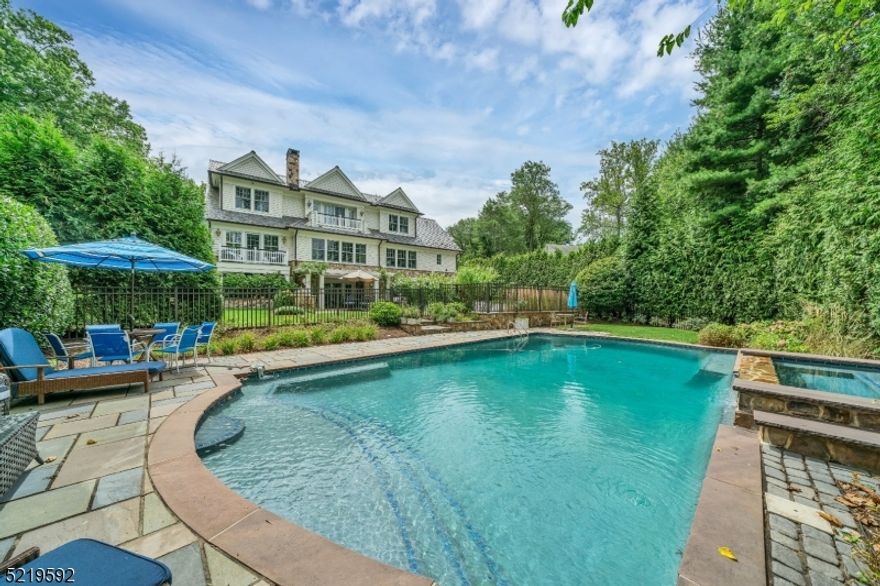 This elegant custom colonial has all of the luxurious details that today's discerning home buyer expects, including an in-ground gunite heated salt water pool/spa, an elevator to all floors and a whole house Generac generator. This home is on .54 acres in the desirable Hartshorn section of Short Hills with 5 bedrooms, 5 full baths and 3 half baths. The exterior is cedar siding, the roof is slate and there are copper gutters. Enter the expansive foyer and be captivated by the custom millwork, wide plank wood flooring and light filled living space. Adjacent to the foyer is the large formal dining room with custom crown molding and wainscoting. The gourmet chef's kitchen has professional appliances, a center island with seating, a pantry closet and separate casual eating area that is open to the living room with a gas fireplace. This home boasts first and second floor primary suites. Both primary en-suite bathrooms have radiant floor heating. A sitting room/office with a deck, a mudroom, laundry room, and 2 powder rooms complete the 1st level. The 2nd level has 3 generously sized bedrooms, 3 full bathrooms, a second laundry room and a large family room/study with a gas fireplace and balcony. The lower level has high ceilings, an en-suite bedroom with a full bathroom, a media room with a second kitchen and interior garage entrance. Walk out the lower level to the patio to the built-in outdoor gas grill, private yard with mature plantings and the in-ground pool.