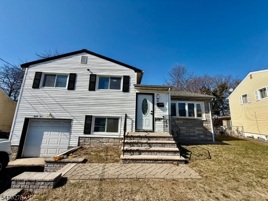 Beautifully Renovated 5-Bedroom Split-Level Home in the heart of Hillside. This spacious, extended-family style home offers a versatile layout and modern upgrades throughout. The main level features a bright living room with cathedral ceilings, dining area, and an updated kitchen complete with quartz countertops and stainless steel appliances. The second level includes three spacious bedrooms, a full bathroom, and a large linen closet. On the lower level, you'll find two additional bedrooms, a full bathroom, direct access to the garage, and an inviting three-season enclosed porch that leads to the backyard perfect for relaxing or entertaining. The finished basement provides even more living space with a flexible office or playroom area and a dedicated laundry room. Ideally located between Route 22, I-78, and the Garden State Parkway, this home offers excellent commuter access to Newark Airport, Jersey City, and New York City.