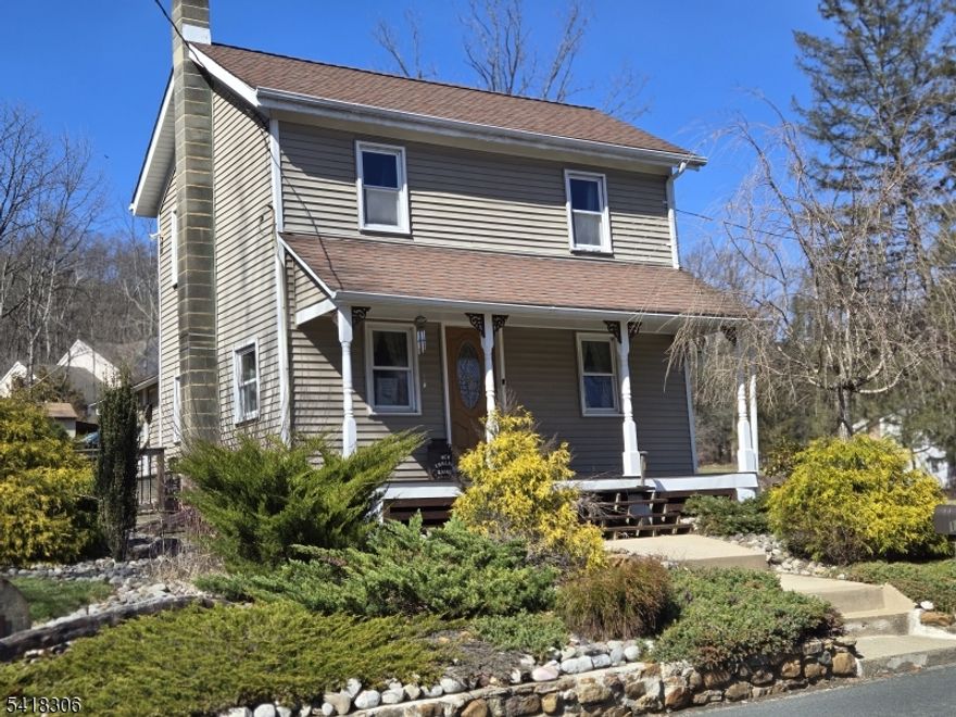 Perfect blend of rural with downtown convenience!   This spacious home is nestled on an acre backing up to woods, and enjoys peaceful views of the 1.58 acres across the street that is included in the sale.  Current owner uses that 1+ acres for extra parking, garage, (in need of repair), and a huge garden.  This home offers pumpkin flooring in 2 of the bedrooms, updated eat in kitchen with granite counter tops and stainless steel appliances, laundry room on the 1st floor.  Efficient wood burning stove, large deck for BBQ's and the septic was replaced about 9 years ago.  Mature landscaping, rocking chair front porch, minutes to downtown shopping at an affordable price!  Lot across the street in not buildable, in a flood zone, has a stream.  House is not in a flood zone.