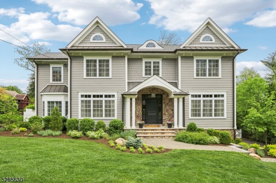 Welcome to luxury living in the heart of Chatham. This gorgeous home epitomizes elegance and sophistication. As you walk through the front door you are greeted by an open floor plan and welcoming atmosphere. The main level features a bright living room, a spacious yet cozy family room with a fireplace, 9-foot ceilings, hardwood flooring, 3-zone heating and cooling, a private guest room w/full bath, elegant dining room, butler's pantry w/wine fridge, gourmet kitchen w/walk-in pantry, center island, stainless steel appliances and breakfast nook. The sliding doors lead you to a massive deck with a gas fire table, outdoor TV, built-in grill, and beverage fridge. Perfect for entertaining guests or simply relaxing outdoors. The second floor features 4 bedrooms, each with walk-in closets. The primary suite offers tray ceiling, massive closet w/center island, huge bathroom w/double sinks, walk-in shower, and large soaking tub. The princess suite has a seating area and full bath, Jack and Jill bedrooms are connected by a full bath with double sinks, and a laundry room. The finished basement features recreational space, fireplace, bedroom, full bath, mudroom and a heated 3-car garage. Exterior features include professional landscaping and sprinkler system. Short walk to downtown Chatham restaurants, shopping, direct train lines into both Manhattan and Hoboken. The home is a true combination of luxury and convenience in a fantastic neighborhood. It is a wonderful place to call home.