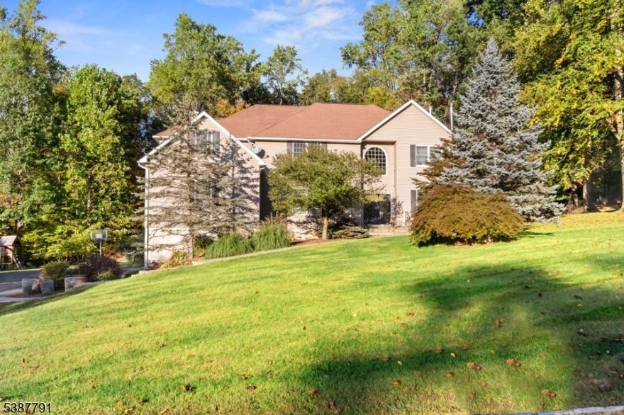 Stunning Colonial set on over an acre, blending timeless charm with modern upgrades in one of the area's most desirable neighborhoods. This spacious home offers 4 bedrooms and 3.5 baths with a flowing floor plan and thoughtful details throughout. The custom kitchen boasts epoxy countertops, stainless steel appliances, and a breakfast nook, opening to a cozy family room with stone fireplace and shadowbox moldings. The oversized primary suite includes a luxurious en-suite with jetted tub and walk-in shower. A large dining room features a built-in wine rack hutch, wine fridge, and wood stove, while an additional second-floor sitting area offers another wood stove. In total, the home includes three wood-burning fireplaces, providing warmth and energy savings during the colder months. Additional highlights include a partially finished walkout basement, 2-car built-in garage, and a paver-stone backyard with seating and fire pit perfect for entertaining. Recent updates include 2 new heat pumps, newer septic (2022), front walkway with pavers, and an expanded backyard with cleared trees. Conveniently located near Route 23, shopping, schools, golf, and Mountain Creek skiing and water park.