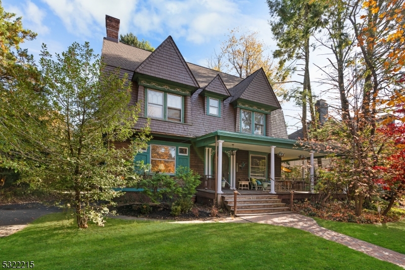 Discover this grand 2-family Victorian in Plainfield's Van Wyck Brooks Historic District.This 6-bedroom, 3.5-BA home also features a spacious 2BR/1BA income-producing apartment, blending classic turn-of-the-century elegance with modern amenities.This stunning residence showcases a cedar shake exterior, a wraparound mahogany porch with classic fluted columns, a new roof and paver walkway, & a carefully crafted addition that maintains the original aesthetic.Enter through the grand center hall to find rich architectural details, including multiple fireplaces, finely crafted hardwood staircases and floors, arched doorways, original pocket doors, leaded glass windows, cozy window seats, and a dedicated library with built-in shelving and reading nooks.The main level includes a formal dining rm, a spacious living rm. with 3 additional fireplaces, a butler's pantry with a half-bath, and an updated EIK.On the 2nd.Fl, you'll find 4 BRS. 2 full Baths, a 4th fireplace, ample storage, and a newly refinished deck/balcony.The 3rd.Fl. houses a separate rental apartment with two bedrooms, a full bathroom, a full kitchen, and a combined living/dining area, complete with its own entrance and balcony.This property includes an impressive 1,000-Sq. Ft. multipurpose entertainment/work space featuring cathedral ceilings, exposed wood beams, a loft area, large porcelain slate-looking tiles, radiant heating, and CA..Nestled in a peaceful area, the property has a paved driveway w/ample pkg.