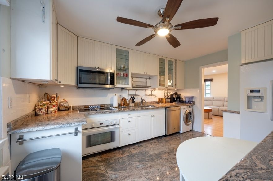 Bright and spacious second-floor 2-bedroom residence set within a quiet, park-like community. This sun-filled home features rich hardwood floors, an open-concept living and dining area, and an electric fireplace that adds warmth and sophistication. The eat-in kitchen showcases timeless, European-inspired design with marble-look tile flooring, custom cabinetry that extends to the ceiling, and elegant glass-front upper cabinets blending charm with refined detail. Bosch cooktop and oven, built-in microwave, new granite countertops, and a convenient in-unit washer/dryer combo.. Both bedrooms are generously proportioned with excellent closet space. The primary bedroom is enhanced by custom-designed closet doors with a decorative finish, adding a subtle designer touch. Three built-in wall A/C units efficiently cool the entire home. Heat, hot water, sewer, trash removal, snow removal, and lawn maintenance are all included in the rent. Residents enjoy access to a beautifully maintained community featuring a built-in pool and professionally landscaped grounds. Located near Briant Park, with its scenic pond, walking paths, and picnic areas. Springfield offers a jitney service to the Short Hills train station, along with easy access to NYC-bound trains and buses, major highways (Routes 22, 78, and the Garden State Parkway), Newark Liberty Airport, and Kean University. Troy Village is a well-maintained, pet-friendly community offering. 700+ credit & verifieable income requirement.