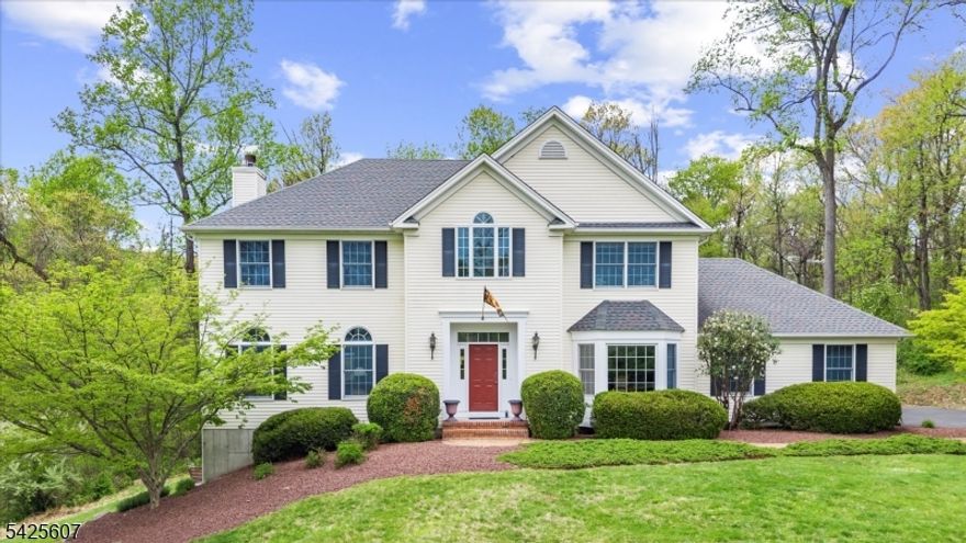 Turn onto Jockey Hollow Road and everything begins to slow down, with mature trees lining the drive and the home set back on nearly two acres where privacy feels natural and uninterrupted. As you arrive, there's an immediate sense of space and quiet that carries throughout the property. Step inside and hardwood floors lead you through a classic colonial layout, starting with a bright living room with built-ins that feels both welcoming and functional. The dining area sits just beyond, offering a comfortable setting for everyday meals or gatherings that tend to linger. The kitchen is both practical and inviting, with white cabinetry that provides clean lines and ample storage, creating a space where everything has its place. It opens to the adjoining living area, allowing for an easy flow that works just as well for hosting as it does for daily routines. Upstairs, four bedrooms provide flexibility, including a primary suite with two walk-in closets. Each room feels settled, with views of the surrounding landscape that shift naturally through the seasons. The partially finished basement offers exceptional flexibility, with space for a den, workout room, in addition to a separate art studio, and a dedicated workshop area. Outside, the 1.98-acre setting surrounds the home in privacy, with trees creating a quiet backdrop for mornings on the deck or evenings spent outdoors. Major updates include a new furnace and air conditioning system in 2025, along with a roof replaced in 2016.