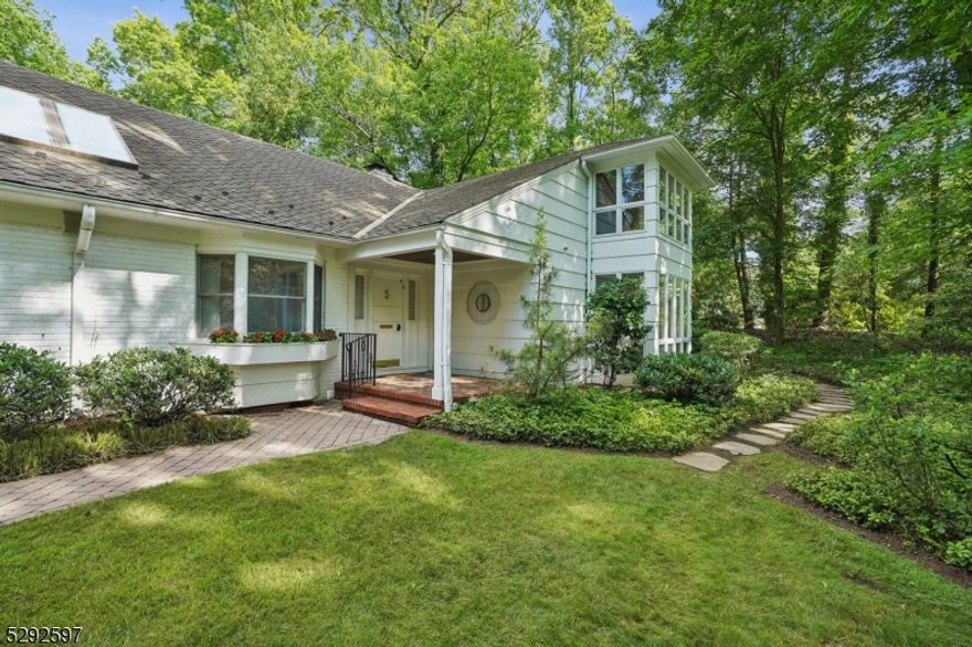 Gorgeous setting in old Short Hills, Hartshorn Elementary School, set on approx .7  acres. Brimming with charm, this five-bedroom +, four-and-a-half bath home offers over 5,400 square feet of living space across three levels, delivering incredible privacy in a park-like setting convenient to top amenities. Its fireside formal living and dining room is lined with floor-to-ceiling windows showcasing a backyard oasis and pool, while French doors fold open to a spacious family room. Nearby glass sliders bring the outdoors in, providing unfettered access to a private paradise for seamless indoor-outdoor living. The expansive kitchen features a timeless center island layout, breakfast nook, roomy sitting area, and conveniently adjacent mudroom/pantry with a laundry center, powder room, and garage access. Across the residence, its first-floor primary suite is accented by a large walk-in closet and updated en-suite bath with jetted tub and stall shower,  complemented by a full first-floor guest suite/private office. Upstairs, four additional bedrooms, two full baths, and abundant storage are centered around a sun-filled sitting room and roof deck. The lower level includes a mirrored exercise studio, dedicated office/craft room, wet bar, temperature-controlled wine cellar, and more storage. With its prime location, coveted lot, architectural pedigree and incredible living space, this home offers endless possibilities for the discerning buyer seeking an exceptional place to call home.