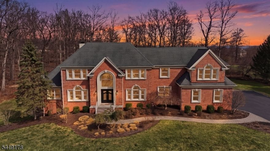 This exceptional property is set on 2.5 acres at the end of a cul-de-sac in Equestrian Meadows Estates, Raritan Township's premier enclave of just 24 luxury homes. Bordering preserved land, it offers a rare combination of privacy, scale, and timeless elegance. A grand marble foyer with sweeping circular staircase sets the tone, leading to a formal living room, a soaring two-story family room with fireplace, and a formal dining room with butler's pantry. The gourmet chef's kitchen features professional-grade stainless appliances, granite countertops, an expansive center island, and a dedicated desk area, ideal for everyday living and entertaining. The flexible floor plan includes a first-floor bedroom option with full bath access, a dedicated private office, mudroom with built-ins, and first-floor laundry. Upstairs, the primary suite with cathedral ceiling offers a sitting room, dual-sided fireplace, dressing room, multiple walk-in closets, and a spa-like bath with jetted tub. Three additional bedrooms include one en-suite with private bath. Outdoor living features an expansive deck and patio with firepit. A 3-car garage and walk-out basement add convenience and future potential. Located just minutes from downtown Flemington's dining, shopping, and amenities, this home offers a refined lifestyle in one of the area's most sought-after luxury communities.