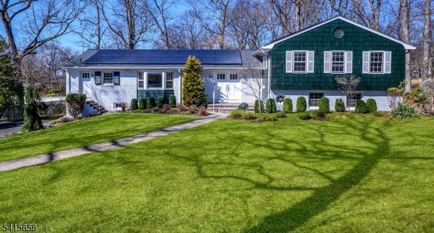 Tucked away on a quiet cul-de-sac and set on over half an acre of beautifully flat property, this expansive Scateri split-level residence offers space, warmth, and a setting that truly feels like home. Sun-filled interiors and large windows bring natural light into every corner, while the open floor plan creates an inviting flow ideal for both everyday living and memorable gatherings. The home features generous square footage throughout, including oversized bedrooms and a spacious primary suite that serves as a peaceful retreat. In 2022, the home underwent a comprehensive roof, solar and infrastructure modernization, thoughtfully updating the home's energy systems to enhance efficiency and long-term comfort. Recent cosmetic improvements include wallpaper removal, fresh interior painting, carpet removal, new flooring, bathroom upgrades, and appliance replacements, giving the home a clean, refreshed feel while leaving room for a new owner's personal touches. An open, unfinished basement offers abundant storage and the potential to create additional living space tailored to your needs. Perfectly located for convenience, the home provides easy access to NYC, major airports, trains, and PATH transportation hubs, while still enjoying the privacy and quiet of a cul-de-sac neighborhood. A rare opportunity to own a bright, spacious home on a large, level property where comfort, light, and connection come together.