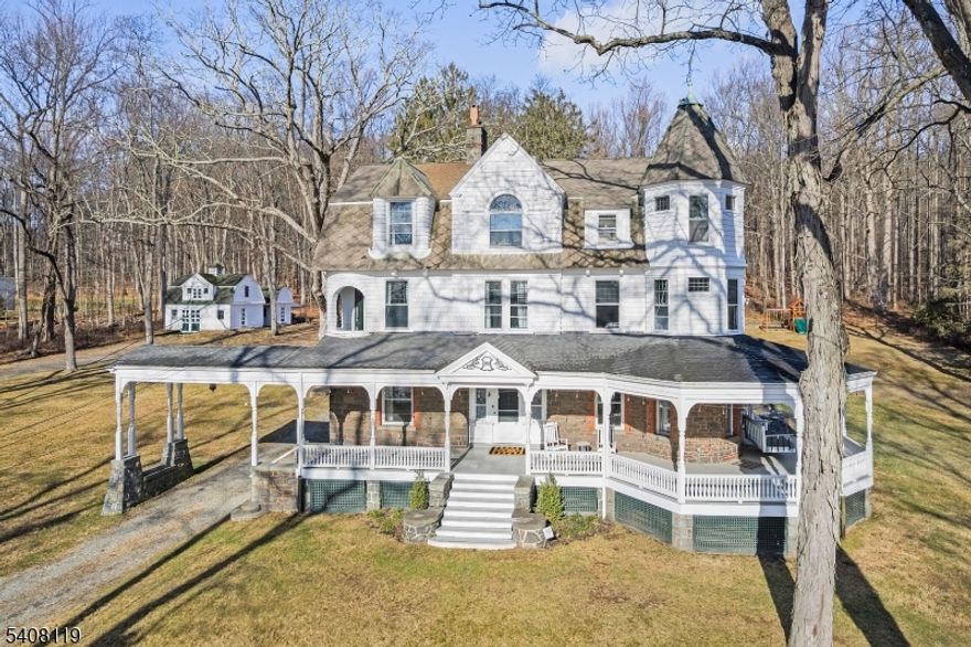 Stunning, beautifully renovated circa 1888 Queen Anne Victorian-replete with welcoming 1,670 sq. ft. wraparound front porch, asymmetrical exterior designs employing stone & patterned shingles, steeply pitched rooflines, round & polygon towers, original stained glass windows, & volume ceilings, plus original custom millworker, period doors & hardware, & hardwood flooring throughout--captures the charm & elegance of a bygone era but with all of today/s modern features & conveniences.  This  majestic home encompasses 4,742 sq. ft. of commodious living space on 3 flowing floors and boasts 14 rooms including 6 airy bedrooms, 3 renovated full baths, updated powder room, with two lovely primary bedroom suite options on separate floors- each with delightful sitting areas and en suite full baths: tasteful living room,  open floor plan family room features a sliding glass door to the inviting bluestone patio: renovated designer kitchen boast granite countertops w stainless steel farm sink, custom cabinetry, premium stainless steel appliances including a Thermador six burner gas range with center griddle & 2 ovens,  elegant dining room measures 27x14. The second & third floors offer high ceilings 6 bedrooms, 3 full baths, laundry room, home office and exercise room. Fully fenced 4.2 acre pancake flat property w restored 2-story barn, newer 6 bedroom septic system, public water, gas heat from newer boiler, brand new 2-zone central air conditioning (2nd & 3rd floors), plus Verizon Fios.