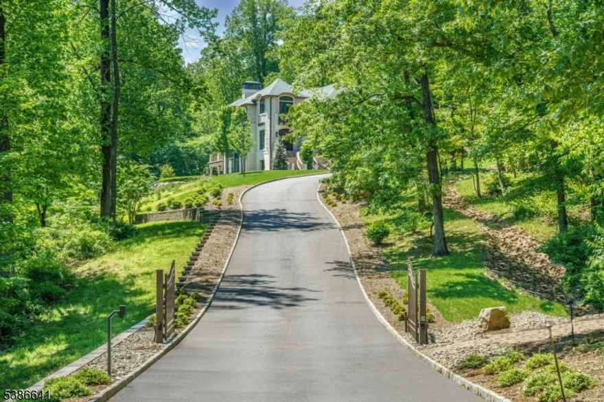 An architectural masterpiece by Jeffrey A. Beer A.I.A., this extraordinary estate is a bold statement in design and innovation. Conceived as both a sanctuary and a showcase, it blends state-of-the-art engineering with artisanal craftsmanship to redefine modern luxury living. From the moment you enter the grand foyer, soaring ceilings and walls of glass create an atmosphere of drama and elegance. Every room showcases uncompromising detail, from a chef's kitchen blending function and artistry to expansive spaces for both intimate and grand gatherings. Exceptional amenities set this residence apart, including a 75-foot custom firing lane, elevator to all levels, and an indoor pool and spa for year-round leisure. A cinematic theater, sprawling recreation rooms and dual outdoor kitchens with patios make this an entertainer's dream. Smart home systems manage lighting, climate, security, audio and automated window treatments with precision to ensure comfort and control at every turn. The private quarters are equally impressive. Four upstairs bedrooms each offer en suite baths to provide a perfect blend of luxury and privacy, while the main level primary suite is an oasis of tranquility, meticulously customized with the finest finishes. Every detail, from materials to proportions, reveals the vision of a master architect. More than a home, this residence is a living work of art that embodies bold design and timeless character, unlike anything else on the market.