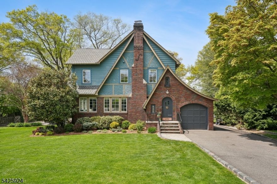 Welcome to your private, resort-style oasis just minutes from Manhattan. Artfully reimagined and steps from both Maplewood and South Orange downtowns, this sun-bathed Tudor is a one-of-a-kind sanctuary combining historic soul with chic design and breathtaking South Mountain views. The 1st level balances warmth and function with effortless style. A sunlit living room with WBF flows into a dining space and family room, both with access to a picturesque covered porch - perfect for morning coffee and sunsets. The chef's EIK anchors daily life, featuring custom cabinetry, soapstone counters, new smart/premium appliances, Vulcan stove, coffee bar, and walk-in pantry. A convenient powder room, mudroom, and garage entrance complete this level. Multiple living areas, including a finished basement with media space, wet bar, and large laundry room, offer flexibility for entertaining and everyday living. Upstairs features three generous BRs with ample closets, Jack-n-Jill bath, and private primary en-suite. The 3rd level offers a 4th BR/office plus a separate lounge and yoga space. The backyard is a true showstopper: a luxury, multi-level retreat centered around a smart-enabled, heated saltwater pool and a wrap-around deck with dedicated BBQ, dining, and lounging areas. Beyond the pool, a professionally landscaped garden with fire pit creates a rare sense of privacy. Designed not just to live in, but to escape to every day.
