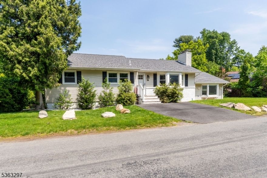 This dream lakefront home welcomes you with breathtaking lake and mountain views through an oversized sliding door. The living room has new hardwood floors and a cozy wood-burning fireplace, complemented by luxurious wainscoting throughout the main level. The open-concept layout flows seamlessly into a renovated kitchen, featuring new appliances, upscale cabinetry, and stunning granite countertops. All three bedrooms and two full baths are conveniently located on the first floor. Beyond the sliding doors, an expansive deck and screened in porch overlooks a lower deck, the yard, and your private dock perfect for entertaining. Off the kitchen, a spacious bonus room with skylights and high ceilings offers an ideal office or game room. Downstairs, the finished basement reveals another bonus room with a stone fireplace and 2 more full bathrooms. You'll also find a laundry room with a newer LG washer and dryer set, a second full kitchen, and an additional bonus room. Large windows provide gorgeous lake views, making this an impressive guest suite. This deceptively spacious, turnkey home is packed with upgrades and attention to detail, including a generator hook-up, a water softening & filtration system, and a new septic as well. Don't miss the chance to make it yours!