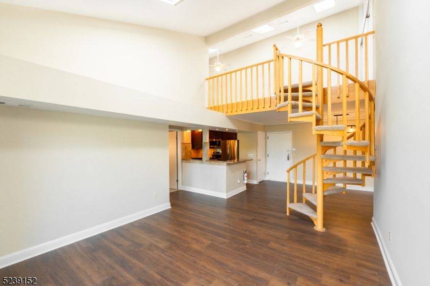 Wow! This NYC style loft has style!.  2 Story END Unit with skylights, Cathedral Ceilings, Spiral Staircase to Loft with Separate Guest/Bonus Room and Renovated Full bath in 2023.  The guest/bonus room has a 1/2 green house type window with treetop and some Morristown Center Views!.  All the carpets upstairs cleaned, paint touch ups throughout the entire unit.  Don't forget the 1st floor's beautiful kitchen with new dishwasher.  Primary bedroom has its own full bath, laundry and multiple closets for ample storage.  The 2nd bedroom is adjacent to the third bathroom and opposite the primary bedroom.  Sliding doors from the open concept living and dining room open to a lovely deck with stone flooring.  Don't forget the extremely close proximity to the center of Morristown, be there in less than 5 minutes to enjoy shopping, live theater, restaurants all centered around its town square.  Have all the fun and hustle and bustle yet come home to peaceful setting and quiet.  The best kept secret in Morristown!.  Unit comes with extra storage unit on 2nd floor.   No stair access to the building and elevator to all floors. Secure building only residents can access lobby or buzz up guests.  Mail is delivered to indoor mail boxes.  1 covered parking space available 1st come 1st served.  This light filled contemporary unit will not last