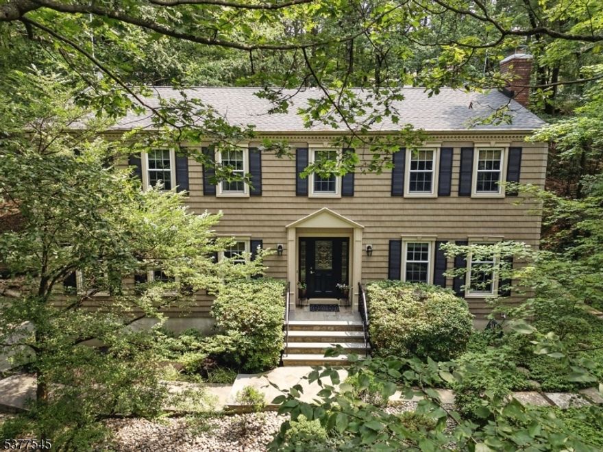 This Spectacular & Beautifully Appointed Center Hall Colonial is nestled in the desirable Union Hill Section of Denville amidst a private, beautiful tree line. Flowing, classic layout great for entertaining. Foyer welcomes you in and is bookended by formal living room & dining. Both boasting gorgeous finishes- moldings & wainscoting. Kitchen with granite countertops & stainless steel appliances overlook the backyard. Large and cozy family room.. Convenient powder room & laundry/mudroom. Gorgeous HW flooring throughout w/moldings. Upstairs 4 large bedrooms and 2 full baths - including a primary suite w/ stall shower. Basement and access to 2 car garage- tons of storage! Parking for 10. Nice and expansive patio! Backyard offers a ton of privacy, backed against half an acre of wooded area. Situated in a great location with easy access to all life's conveniences- close proximity to NYC-Direct train station- Denville & Morris Plains, bus stops, Union Hill Shopping Center & parks. Enjoy bustling Dwtn Denville, Morristown, or Chester. EZ access to major hwys, mass transit & top-rated schools.