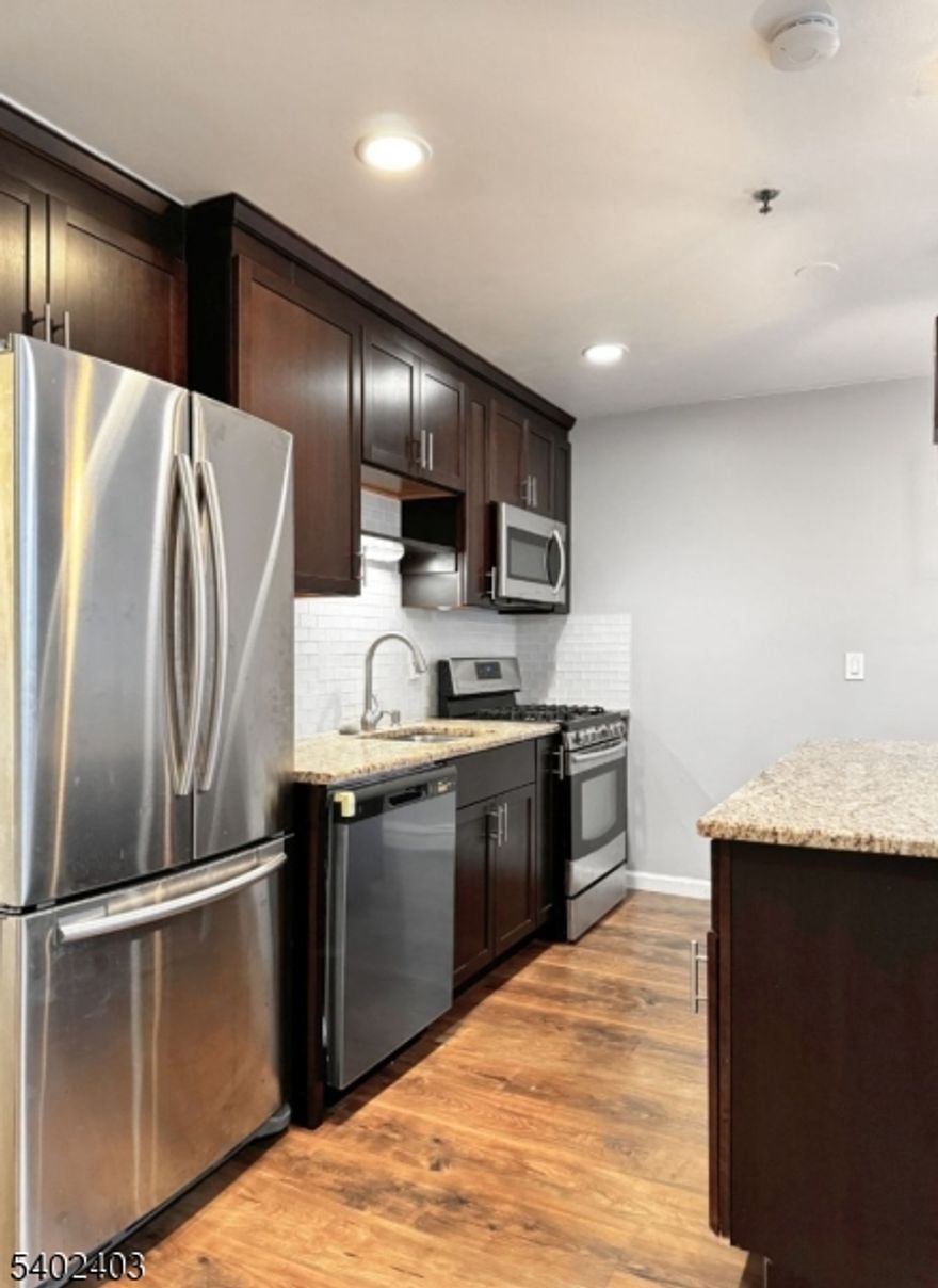 Unique Loft Living Awaits! This stylish and versatile 1-bedroom loft unit features an incredible sky-lit upper loft. The modern kitchen is a chef's delight, boasting granite countertops, stainless steel appliances, and a brand-new dishwasher being installed. Enjoy ultimate convenience with new in-unit laundry and assigned parking. Durable laminate flooring flows throughout the multi-level layout. Comfort is ensured year-round with baseboard heating, multi-level AC. Don't miss this opportunity for a truly unique living space!