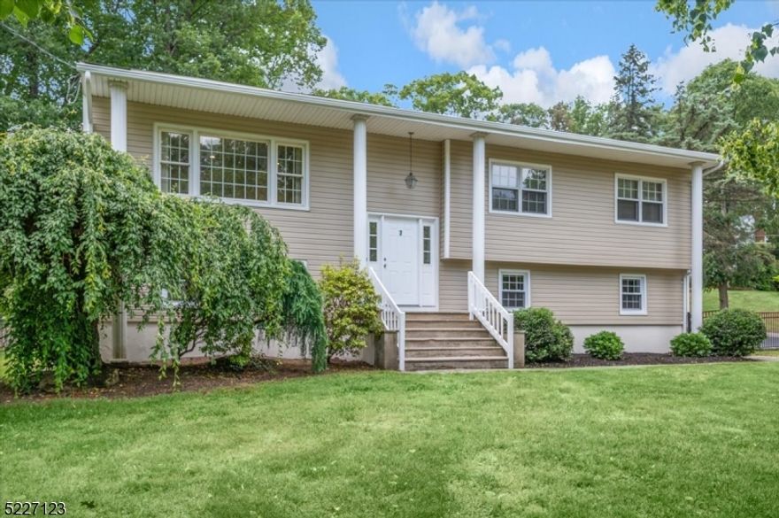 Nestled on a charming corner lot, sits a newly renovated home that exudes a sense of warmth and modernity. This home has been renovated from top to bottom with new roof, siding, driveway & appliances with beautifully refinished hardwood floors on the 1st level & new carpet on the ground level. Public utilities + Central AC. Enter to a large landing with a double hallway closet that opens onto a bright and stunning living room. First floor boasts 3 Bedrooms + 2 Full Baths, open concept living/dining room & brand-new eat-in kitchen w/stainless steel appliances, sleek countertops, subway-tiled backsplash & ample storage. Primary bedroom includes a renovated en-suite + 2 closets. The upgraded hall bath exudes luxury & style, with elegant fixtures & finishes. Two additional bedrooms are nicely sized w/ceiling fans & nice closets. The ground level has the 4th bedroom, a full bath, dedicated laundry, utility room, additional storage and a large family room w/sliding glass doors opening to fully fenced-in private backyard + fully fenced-in side and front yard, adding more outdoor space! A fully finished, oversized 1.5 car garage (1 regular-sized car + 1 small subcompact or motorcycle) with natural light and inside entrance complete this level. Conveniently located minutes from top rated schools, I-80, Rt. 46 & Rt. 10, restaurants, shops and direct train to NYC.  This renovated gem is ready to embrace its new owners with open arms.