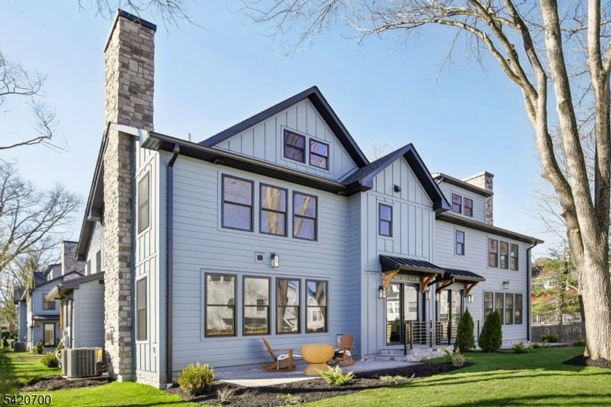 Welcome to Central Villas, a refined end-unit townhome in the heart of New Providence, & a seamless blend of modern design & effortless living. Built by Summit General Construction, this 4-level residence spans approx. 4,450 sq ft, offering 4 bedrooms, 5 full baths, & a versatile 1st-floor office or optional 5th bedroom.Designed for modern living and effortless entertaining, the home features hardwood flooring throughout. The main level showcases a striking living area anchored by a sleek gas fireplace, while the formal dining area opens to a private yard patio, creating seamless indoor-outdoor flow.The chef's kitchen offers custom cabinetry, a waterfall island, premium Thermador appliances, & a pantry just off the garage entry,a coat closet.The 2nd floor features 3 bedrooms each with a Walk In Closet., & the primary suite offers a tray ceiling & spa-like bath with soaking tub, frameless glass shower, & designer vanities. A full hall bath & laundry complete the level.The top floor offers a sunlit, private suite with soaring ceilings, an en-suite bath, & storage, perfect for guests, work, or quiet retreat.The finished lower level adds even more living space, with porcelain tile flooring, decorative wall paneling, a modern electric fireplace insert, & a full bath ideal for a media lounge, recreation area, or home gym. Additional highlights include a 2-car garage with appx.12-ft ceilings, EV charger, energy-efficient systems, smart keyless entry, & a 10-year builder warranty.