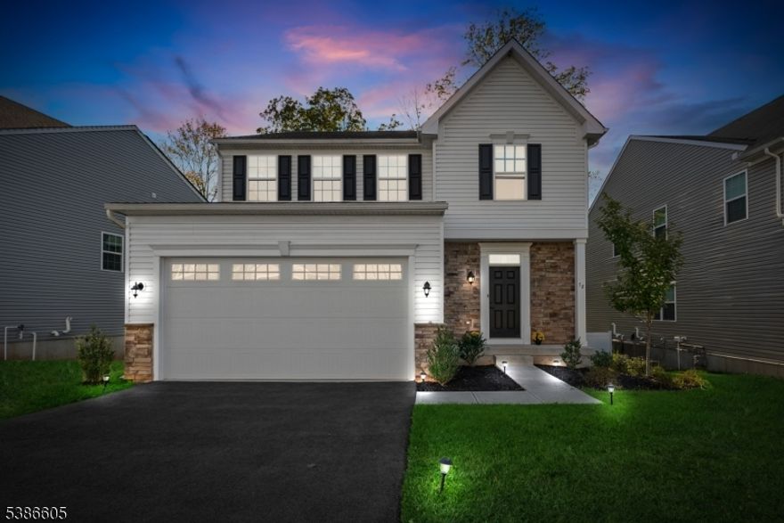 Step into The Stanhope, the largest floor plan in Perryville Ridge, perfectly situated on a northeast-facing, desirable lot with a private wooded backyard. Ideally located across the street from the elementary school and less than a mile from I-78, this stunning 2022 Colonial offers over 4,000 sq ft of thoughtfully designed living space, including an open-concept main level with a spacious morning room, a gas fireplace in the living room, and a bright first-floor office/den with French doors perfect for working from home.The high-end, luxury kitchen features quartz countertops, stainless steel appliances, a gas cooktop, and double wall ovens, while the finished garage with epoxy flooring and EV charger adds convenience and style. Upstairs, the oversized primary suite boasts a huge walk-in closet and luxurious upgraded bath, along with three additional bedrooms, a large beautifully upgraded main bath, and a convenient second-floor laundry room, fitted with Samsung washer and dryer and a convenient sink.  The full finished walk-out ground level, complete with its own full bath, integrates seamlessly into the home, offering versatile space for guests, recreation, or a home gym. Additional comforts include underground sprinklers, natural gas, public water and sewer, and the peaceful wooded backyard, all within a highly desirable Perryville Ridge neighborhood. Enjoy community perks including 6 public parking spaces, a dog park, pickleball courts, walking paths, and a playground.