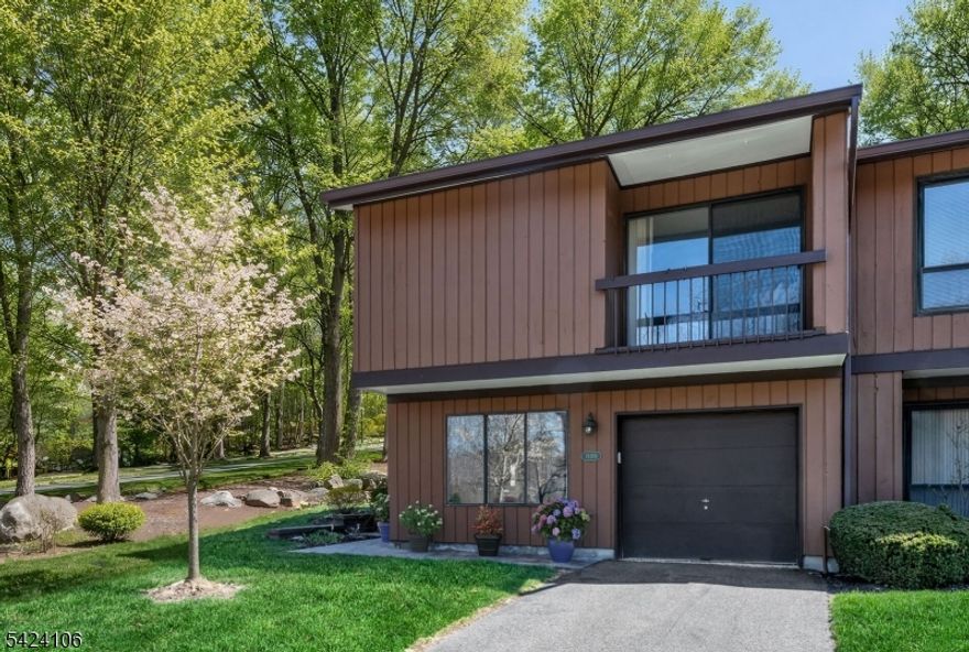 WELCOME HOME to this lovely ENDUNIT TOWNHOME in desirable Overlook Village, beautifully situated on a wooded and landscaped corner lot, deep in the heart of the community. LOCATION MEANS EVERYTHING and you will love the tranquil privacy of the surrounding beauty of nature here. This multi level home is nicely spread out over three levels plus a basement and features an open concept contemporary flair. Natural light streams through many windows and sliding glass doors, unique to the design of this endunit and not found in interior units! Step inside on the first floor to a convenient garage entry right into the eat in kitchen, leading to the formal dining room with sliders to the outside patio. The spacious living room has a vaulted ceiling, fireplace and sliders to backyard deck. Two spacious bedrooms and a full bath are upstairs, with an adorable balcony off the primary bedroom suite. Finished basement space is for the laundry room, storage area and a family room/recreation room. This thoughtful design is perfectly set up for dedicated space when working from home. Enjoy the great outdoors year round from your patio, deck and balcony, plus all of the community amenities which include an in ground pool and tennis/pickleball courts. With easy access to all major roads, schools and shopping and an easy NYC commute. A DO NOT MISS opportunity to own and enjoy a carefree lifestyle in perhaps the best location of the entire community.