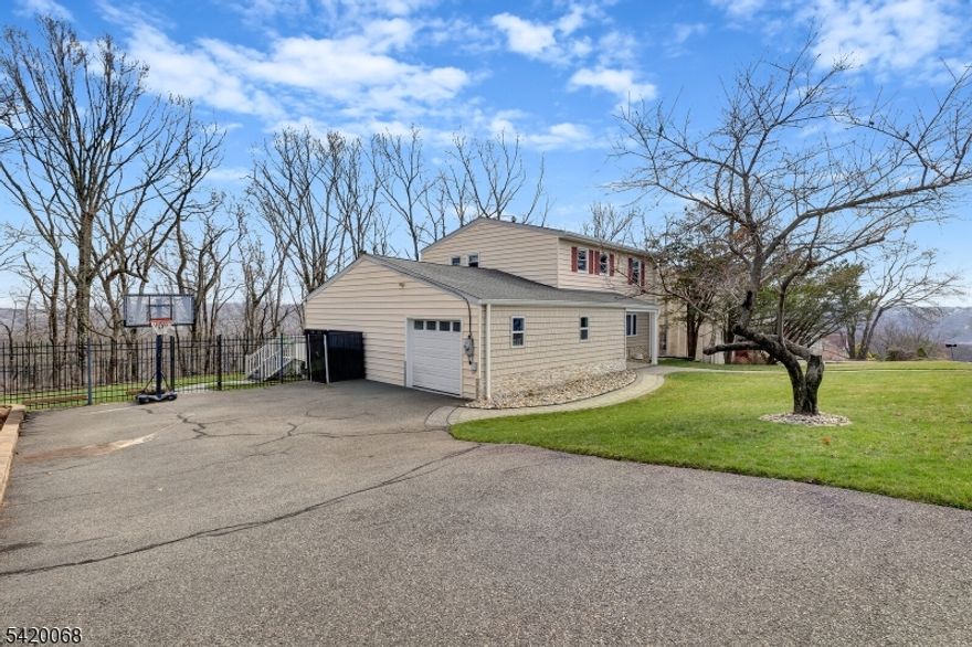At the top of the Mountain Charming Colonial Home, surrounded by great view this home features on the main floor features a formal dining room, open concept to a huge dream spacious eat-in kitchen with breakfast bar adjacent to an expansive family room that opens up to upper tremendous large upper deck with a built in Pro BBQ Grill and a Pizza Brick oven, that connects to lower all paved patio and yard all aluminum fenced around, still on main floor there is half bath, garage, and laundry with slop sink. From the main floor  there is a side stairs to 2nd floor hallway with  4  good size bedrooms and 2 full bath. Including a primary suite with stall shower bath. At the lower level there is an ample finished basement slab with a walk out sliding doors to a fantastic paved patio area, great for outdoor activities. Really beautiful neighborhood in great school system. Property is very airy, lots of natural light. A true perfect blend of comfort and location! ..Don't missed ..it certainly won't last long ! This is must go see Home !HIGH AND BEST ALL OFFERS DUE ON WEDNESDAY APRIL 15th at NOON