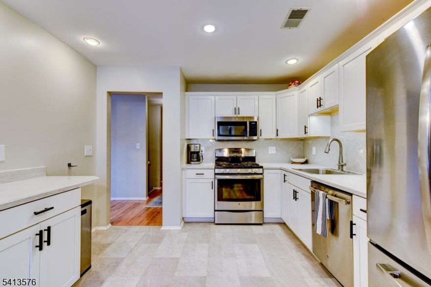 You will love the tranquil wooded views and exceptional privacy in this spacious 3-bedroom, 2.5-bath townhome one of the larger models in the highly sought-after Willow Walk community. This home sits in a prime location backing directly to the beautifully wooded Emmans Park, offering a peaceful natural backdrop from your deck and from nearly every window. The open floor plan features an updated, modern kitchen with white shaker cabinets, stainless steel appliances, a beautiful herringbone tile backsplash, under-cabinet lighting, newer counters, and updated flooring. All bathrooms have been renovated, including a standout primary bath with an expansive dual-sink vanity and a custom walk-in shower. The primary suite also features a generous walk-in closet. The main bath and powder room offer the same fresh, modern finishes. The large 2nd bedroom is like a second primary, with its own walk-in closet. Additional highlights include crown molding, vaulted ceilings with skylights, recessed lighting, abundant natural light, and excellent closet and storage space. The large third-floor storage room has been converted into a functional office ideal for today's lifestyle. Willow Walk has great amenities including a beautiful pool, sports courts, and playground. This pet-friendly community is conveniently located near shopping, dining, major commuting routes, and endless outdoor recreation. A beautifully updated home in a premium setting, ready for you, its next owner!